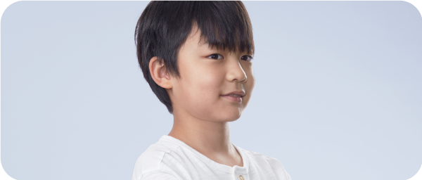 A chinese boy standing and smiling